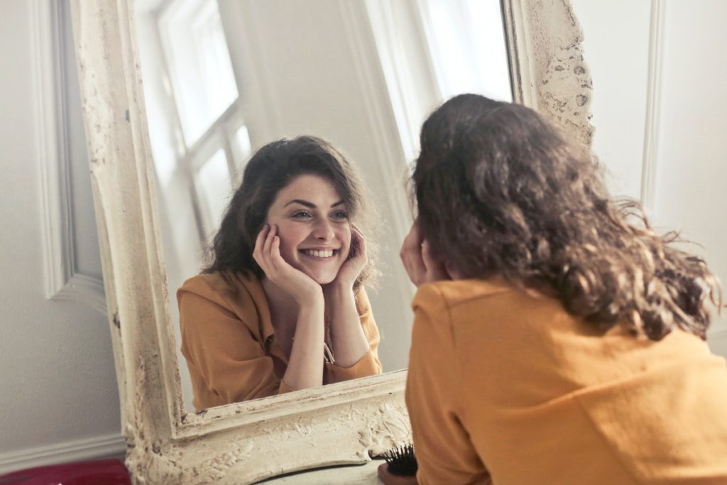 woman in front of a mirror