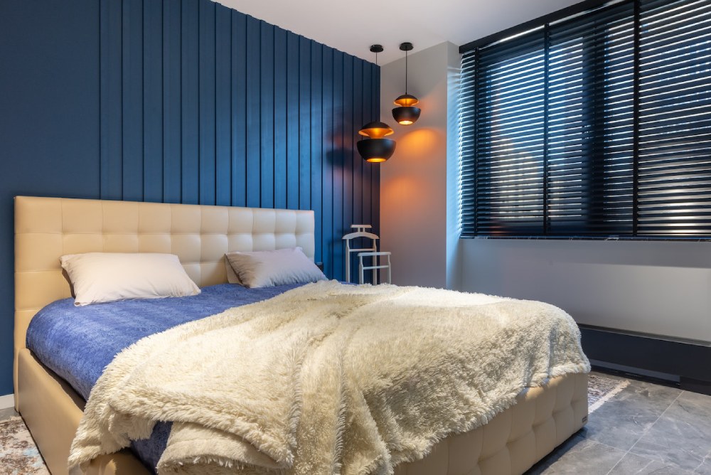 Bedroom interior with plaid on bed at home